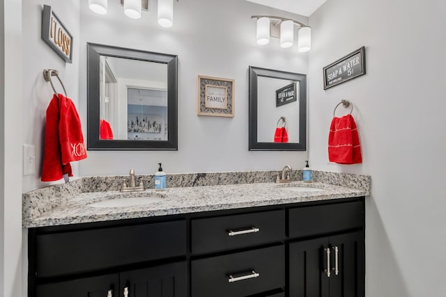 full bathroom with double vanity and a sink