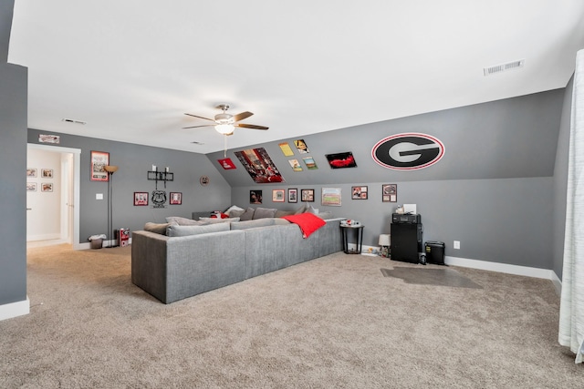 living area featuring light colored carpet, a ceiling fan, baseboards, vaulted ceiling, and visible vents