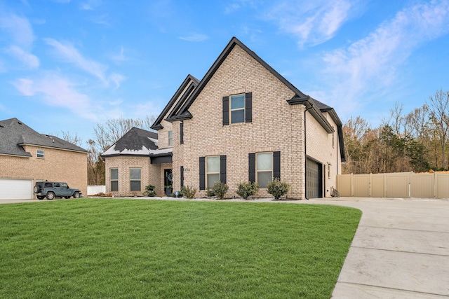 view of front facade featuring brick siding, driveway, a front lawn, and fence