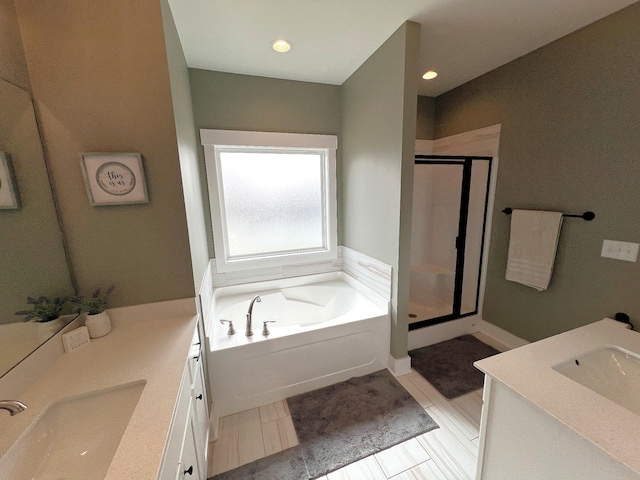 full bath with a garden tub, a shower stall, and vanity