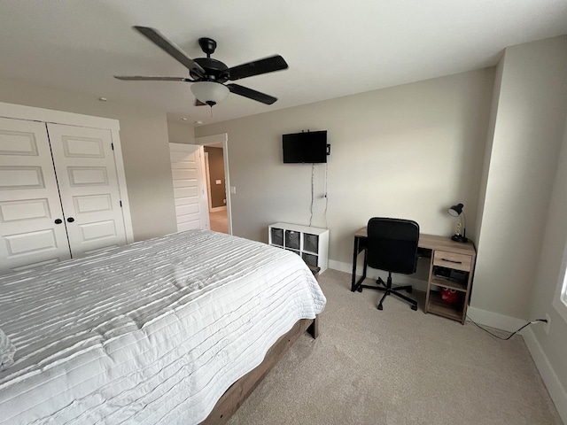 bedroom with a closet, carpet, a ceiling fan, and baseboards