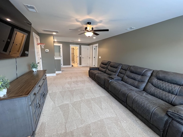 living room with visible vents, ceiling fan, light carpet, and baseboards