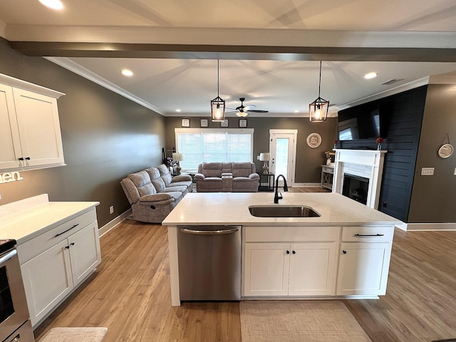 kitchen featuring white cabinetry, open floor plan, stainless steel dishwasher, and light countertops