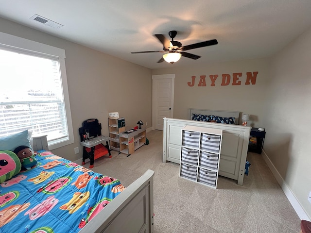 bedroom with light colored carpet, visible vents, ceiling fan, and baseboards