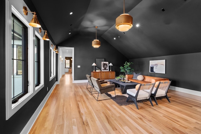 dining room featuring vaulted ceiling and light hardwood / wood-style floors