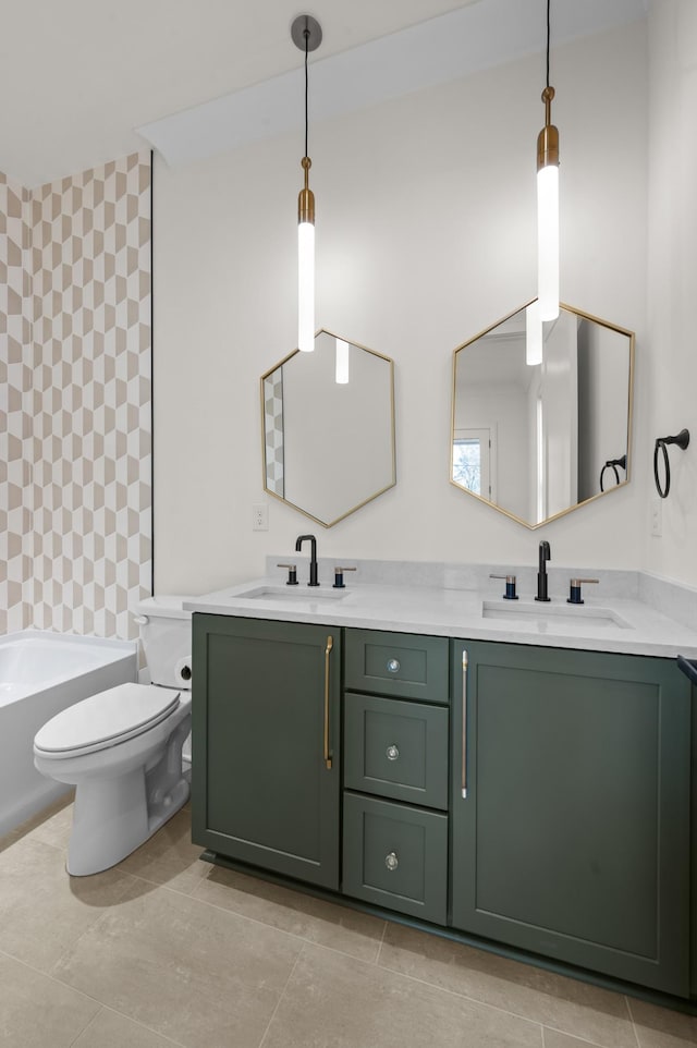 bathroom featuring vanity, toilet, and a tub to relax in