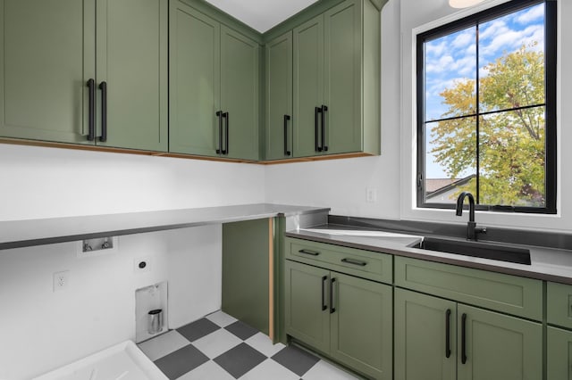 laundry room with hookup for a washing machine, sink, hookup for an electric dryer, and cabinets