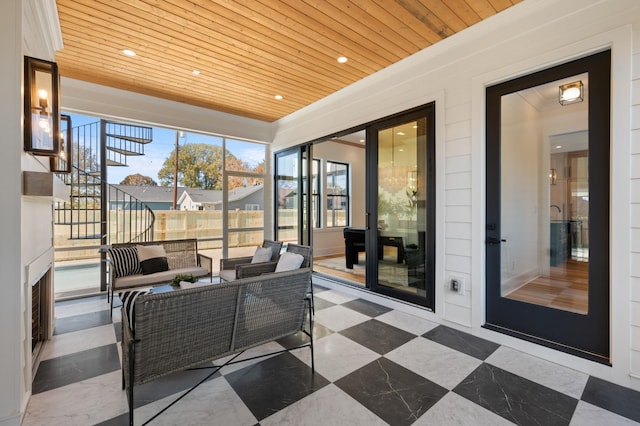 sunroom / solarium featuring wood ceiling