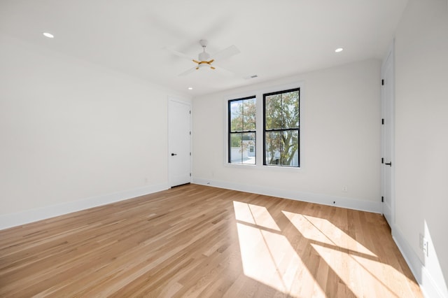 empty room with light hardwood / wood-style floors and ceiling fan