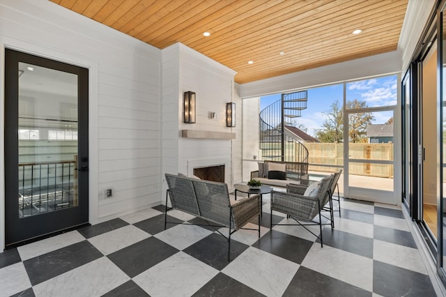 sunroom / solarium featuring wooden ceiling and an outdoor fireplace