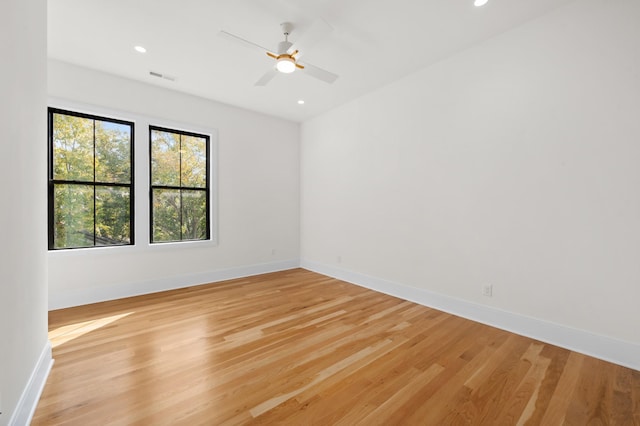 spare room featuring ceiling fan and light hardwood / wood-style flooring