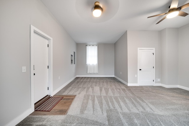 carpeted empty room featuring ceiling fan