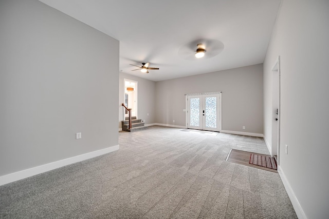 unfurnished room with french doors, light colored carpet, and ceiling fan