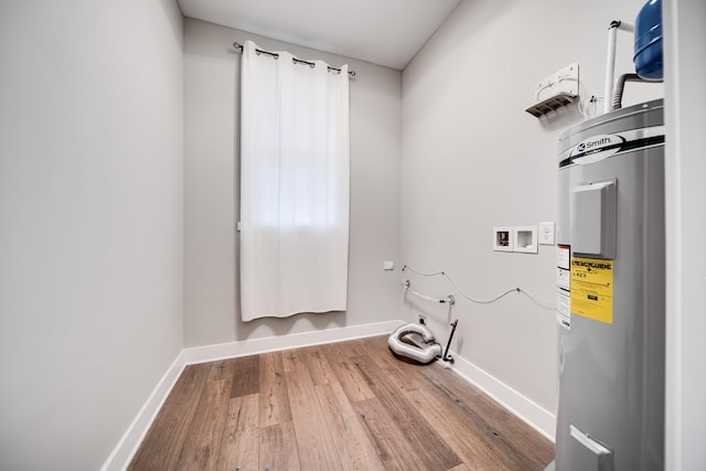 laundry area with hardwood / wood-style floors, water heater, and hookup for a washing machine