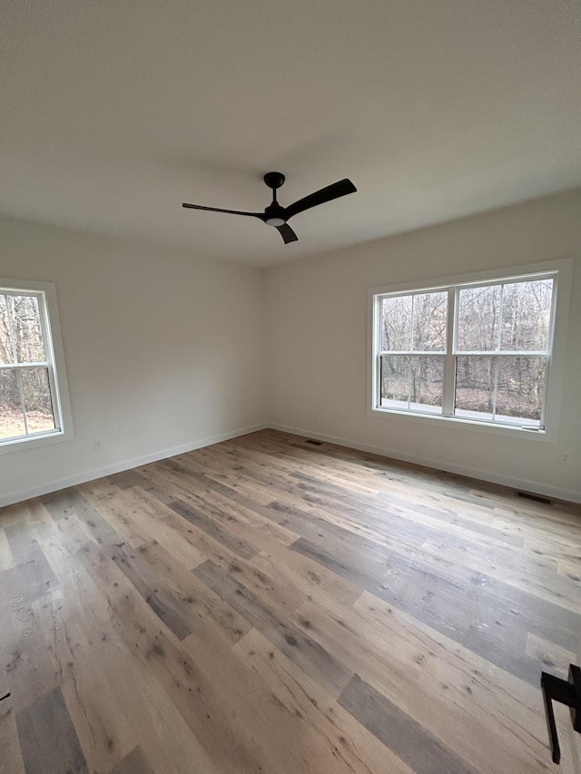 empty room featuring ceiling fan and light wood-type flooring