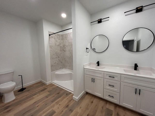 bathroom with toilet, hardwood / wood-style flooring, and vanity