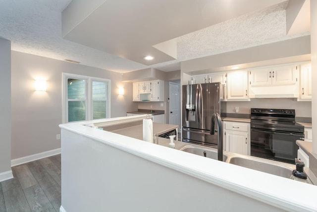 kitchen with a textured ceiling, dark hardwood / wood-style floors, white cabinetry, stainless steel fridge with ice dispenser, and black electric range oven