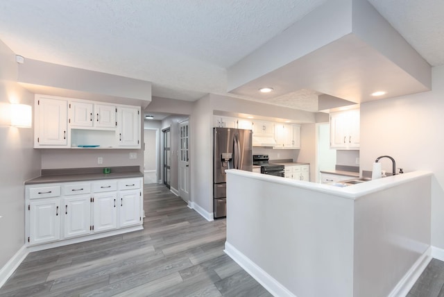 kitchen featuring light hardwood / wood-style flooring, white cabinetry, sink, and appliances with stainless steel finishes