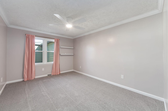 spare room with ceiling fan, carpet floors, a textured ceiling, and ornamental molding