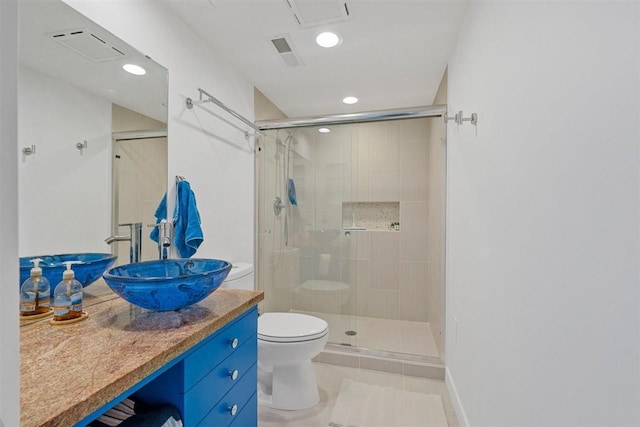 bathroom with tile patterned floors, toilet, vanity, and an enclosed shower