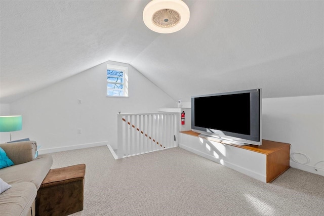 carpeted living room featuring vaulted ceiling