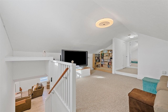 interior space with light carpet and vaulted ceiling