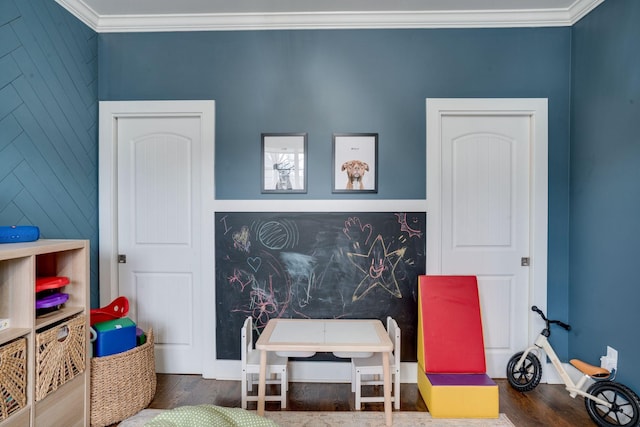 rec room with crown molding and dark hardwood / wood-style flooring