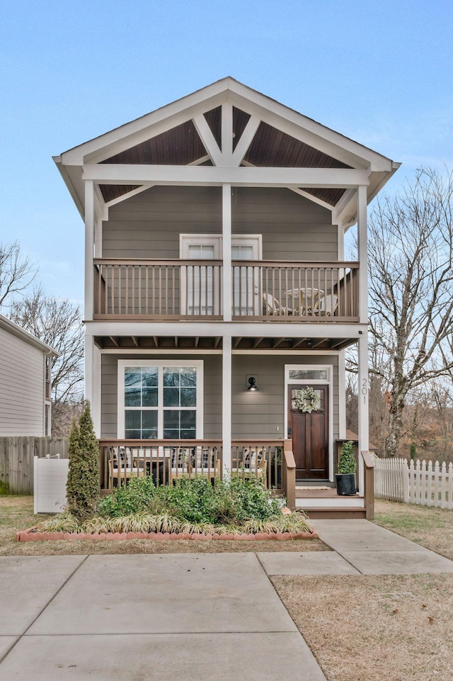 view of front facade with covered porch and a balcony