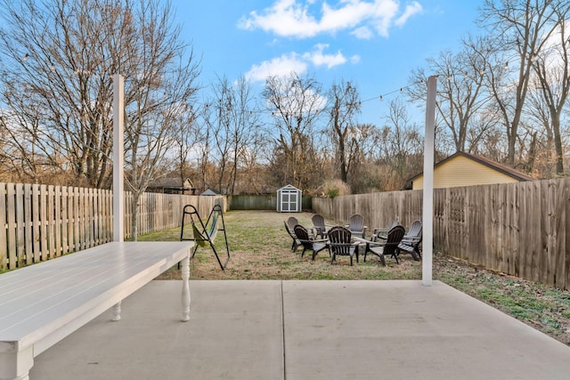 view of patio featuring a storage unit and a fire pit