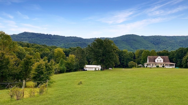 property view of mountains featuring a rural view and a view of trees