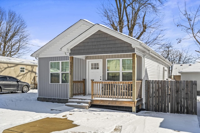 view of front of house with board and batten siding and fence