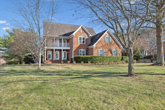 view of front of home featuring a balcony and a front lawn