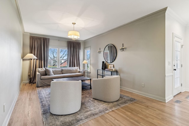 living room featuring light hardwood / wood-style floors and crown molding