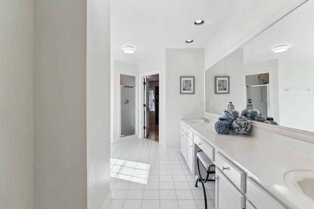 bathroom with vanity, tile patterned flooring, and walk in shower