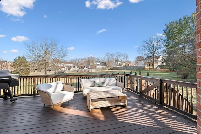 wooden terrace featuring area for grilling and a lawn