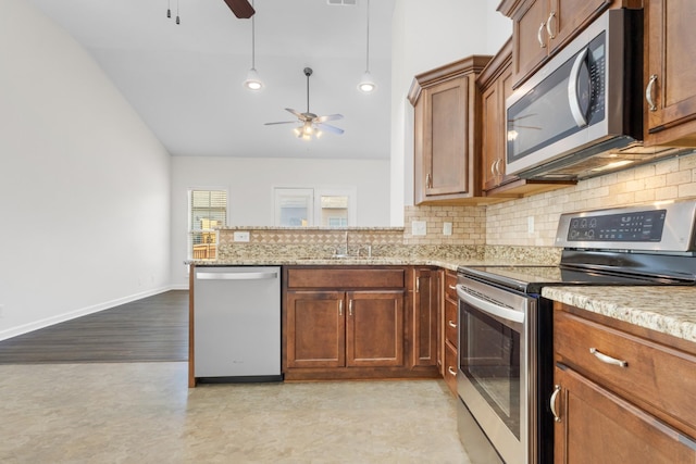 kitchen with stainless steel appliances, light stone counters, and tasteful backsplash