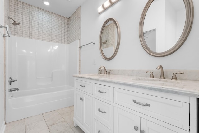 bathroom with vanity and shower / washtub combination