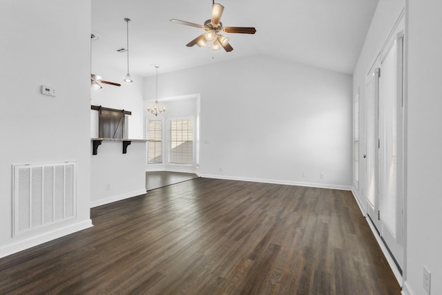 unfurnished living room with a barn door, lofted ceiling, dark hardwood / wood-style floors, and ceiling fan with notable chandelier