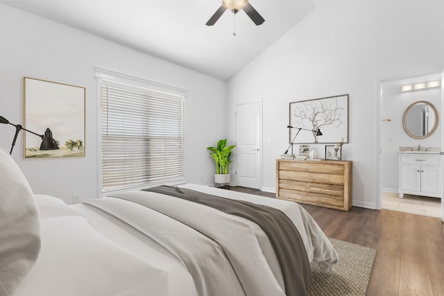 bedroom featuring connected bathroom, lofted ceiling, and dark hardwood / wood-style floors