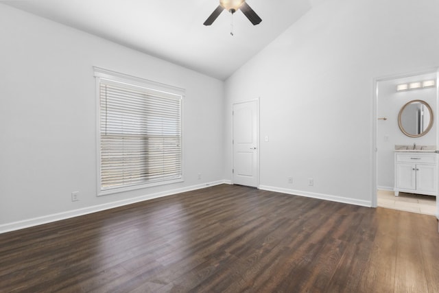 spare room featuring ceiling fan, dark hardwood / wood-style floors, and lofted ceiling