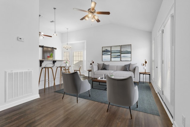 living room with vaulted ceiling, dark hardwood / wood-style flooring, and ceiling fan with notable chandelier