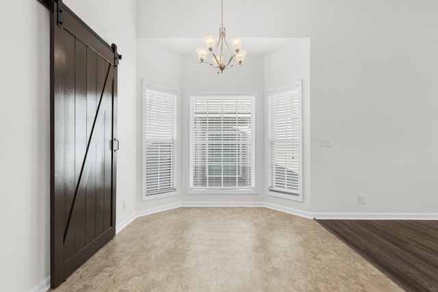 interior space with a barn door and a notable chandelier