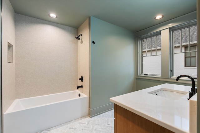 bathroom with vanity and tiled shower / bath