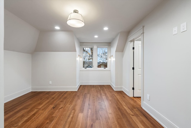 additional living space with lofted ceiling and dark hardwood / wood-style flooring