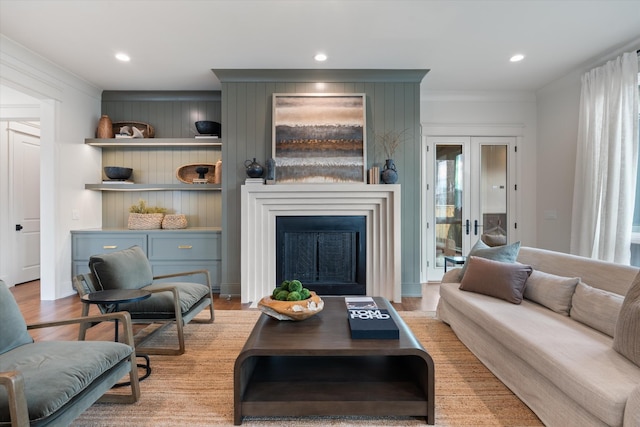 living room featuring ornamental molding, light hardwood / wood-style floors, and a wealth of natural light