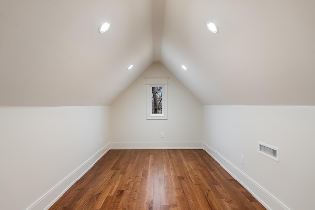 bonus room with lofted ceiling and wood-type flooring