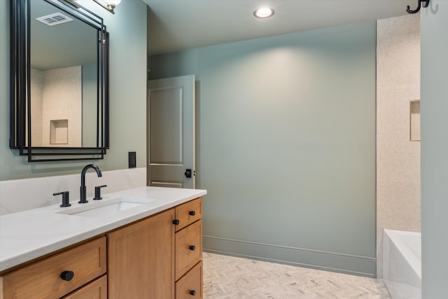 bathroom with vanity and a tub