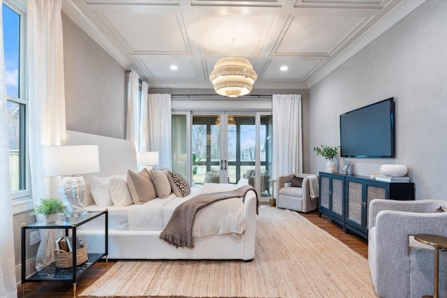 bedroom with coffered ceiling, crown molding, hardwood / wood-style flooring, french doors, and access to exterior