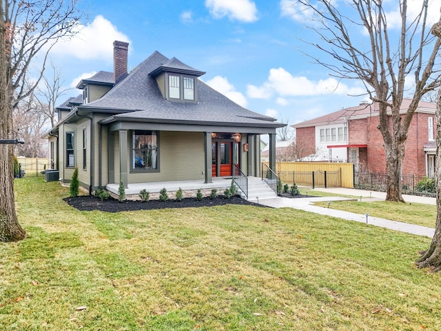 bungalow featuring covered porch, central AC, and a front lawn