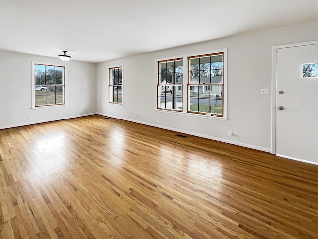 unfurnished living room featuring hardwood / wood-style floors